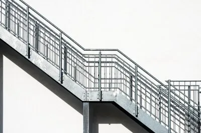 metal-stairs-white-building-wall_181624-25680_12_11zon