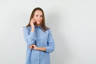 young-woman-talking-mobile-phone-smiling-blue-shirt_176474-22446_22_11zon